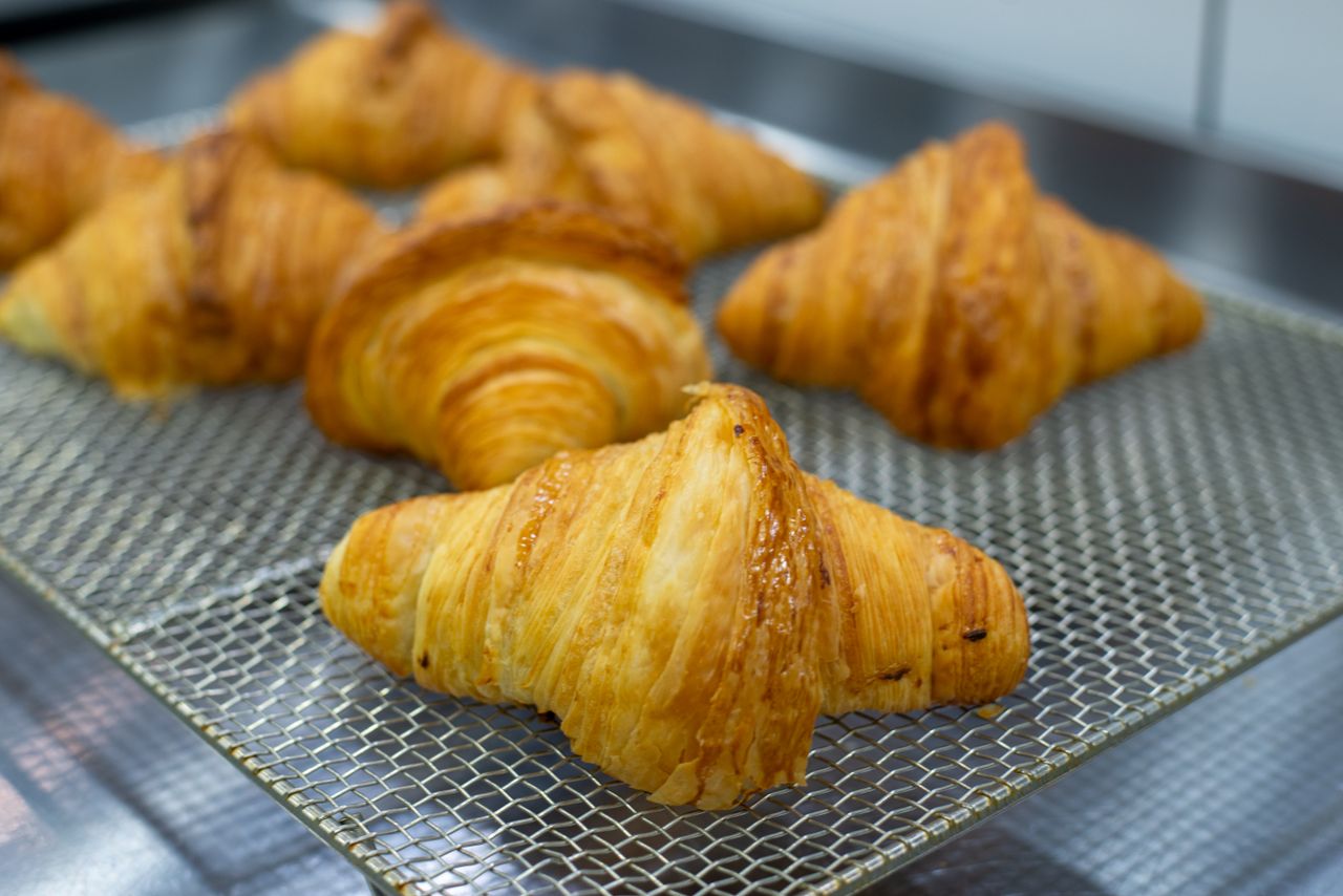 Butter croissants cooling on a wire rack
