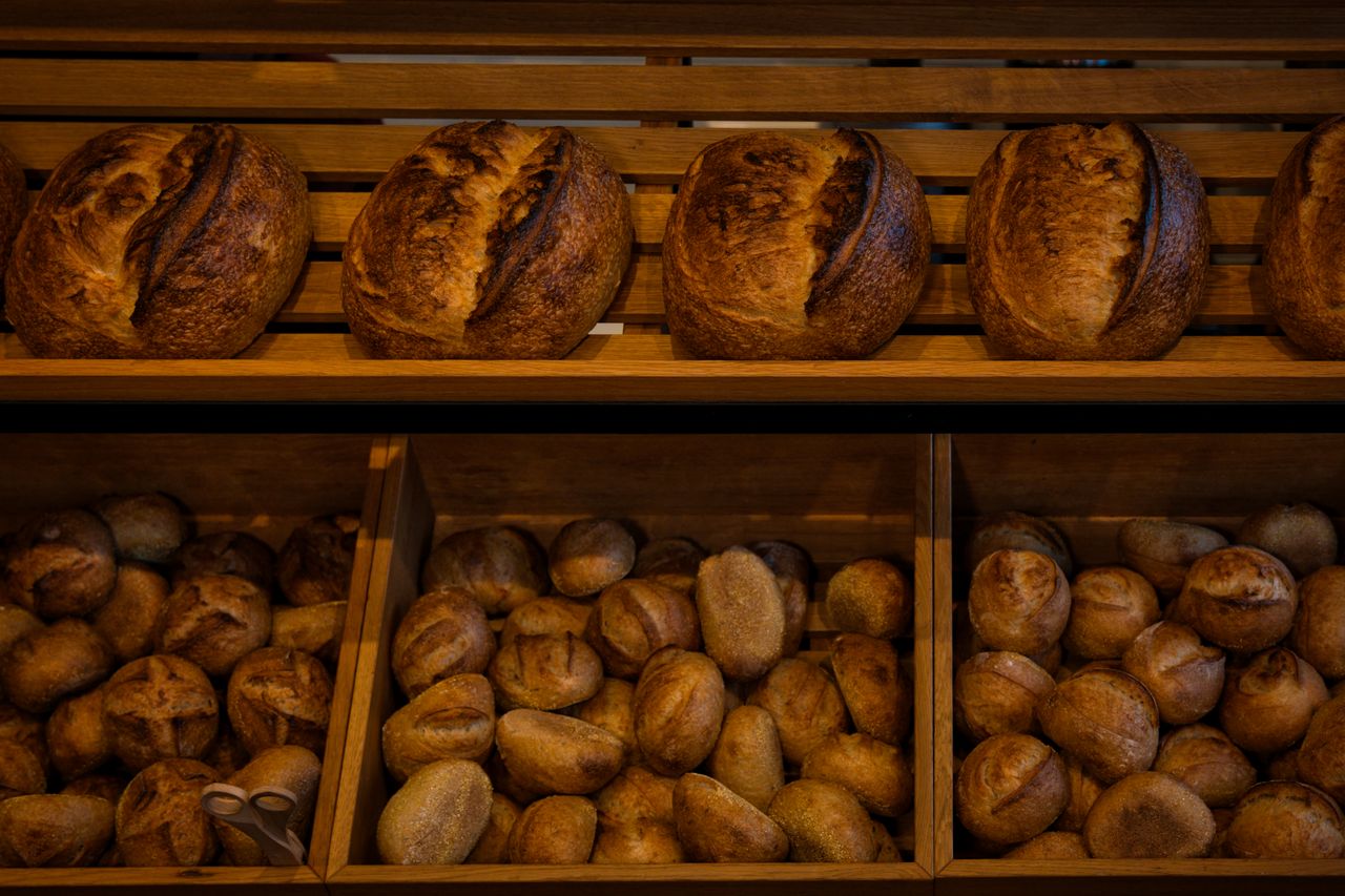 Freshly baked sourdough loaves cooling on the bakery counter